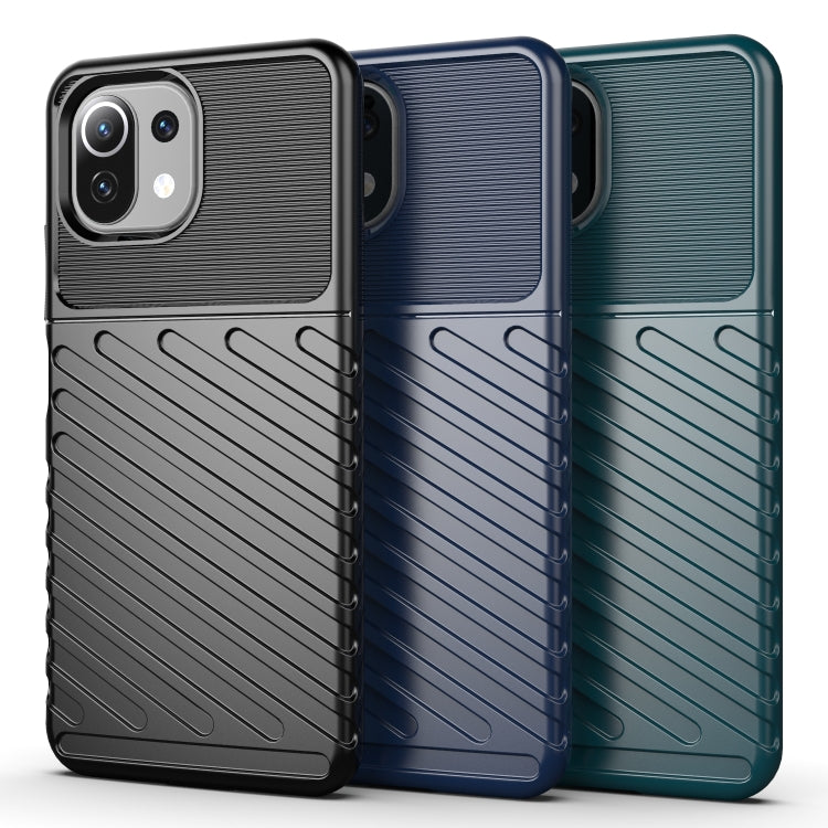 Ribbed TPU phone cases in black, blue, and teal with raised camera bezels