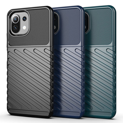 Ribbed TPU phone cases in black, blue, and teal with raised camera bezels