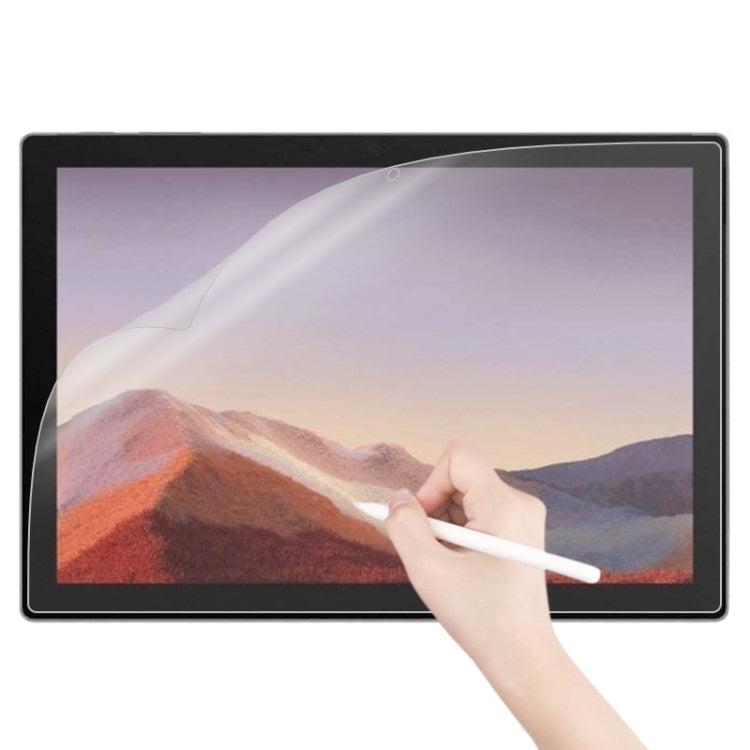 Matte paperfeel screen protector on tablet, hand smoothing the screen film
