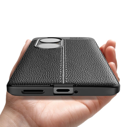 Black textured TPU phone case held in hand, with dual camera lens cutout