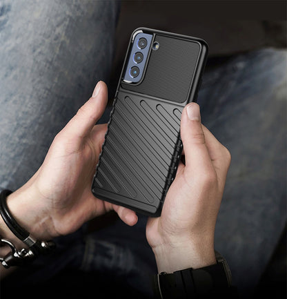 Black shockproof TPU phone case with ribbed texture and camera openings in hands