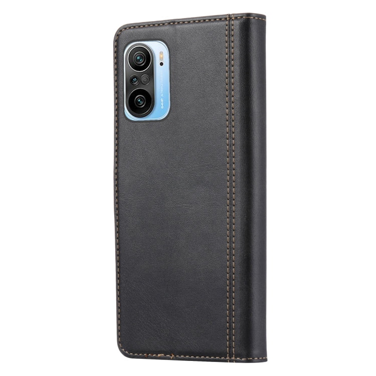 Black leather flip phone case with camera cutout and contrast stitching.