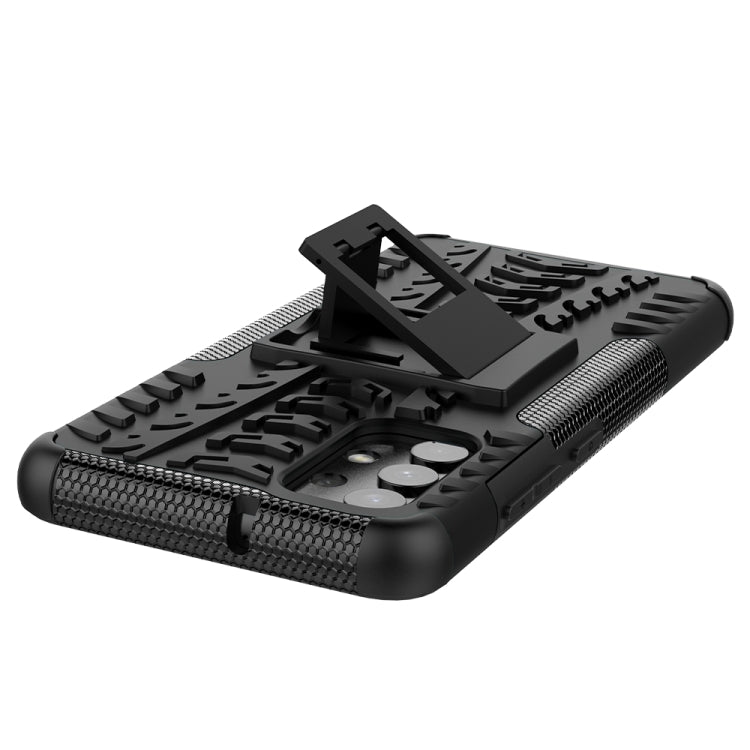 Black rugged phone case with tire tread texture and raised holder for viewing