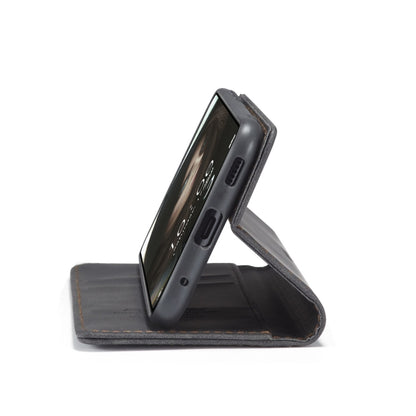 Black leather phone case displayed on its stand with flip cover open