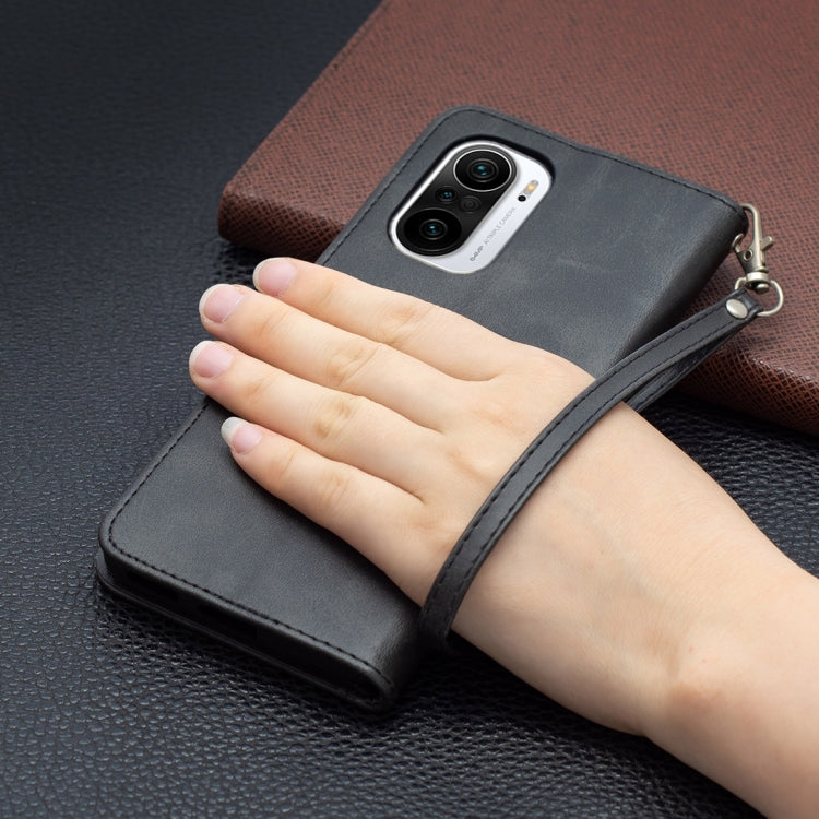 Black PU flip phone case with wrist strap and camera cutout