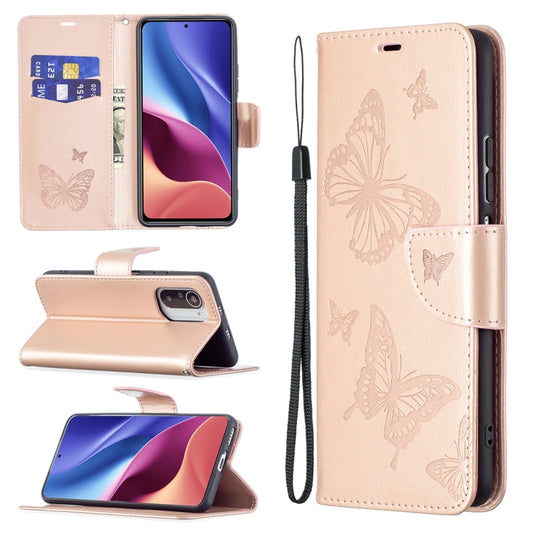 Rose gold leather phone case with embossed butterfly pattern, card slot, and lanyard