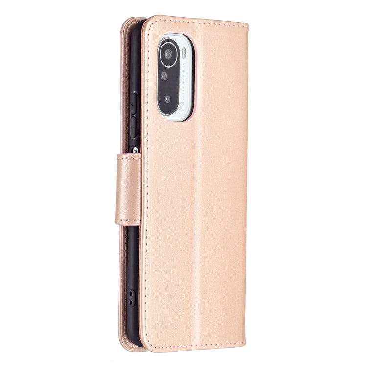 Rose gold leather phone case with embossed butterfly, slim profile, and camera cutout