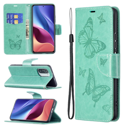 Green leather phone case with embossed butterfly pattern, card slot, and lanyard