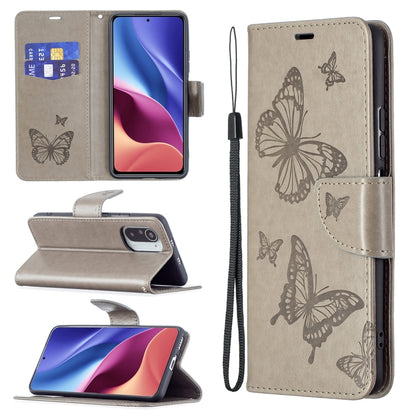 Gray leather phone case with embossed butterflies, card slot, and lanyard