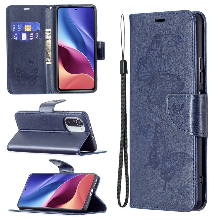 Dark blue leather phone wallet case with embossed butterflies, card slots, lanyard strap