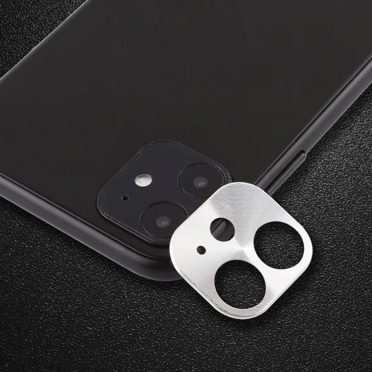 Silver rear camera lens protective film on phone back, cardboard-style cutout