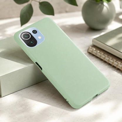 Green liquid silicone phone case on a phone; camera cutout and side openings visible.