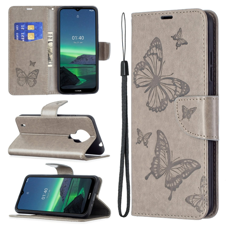 Grey PU leather flip phone case with embossed butterflies, card slot, and wrist lanyard