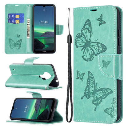 Seafoam green PU leather phone wallet case with embossed butterfly pattern and wrist lanyard