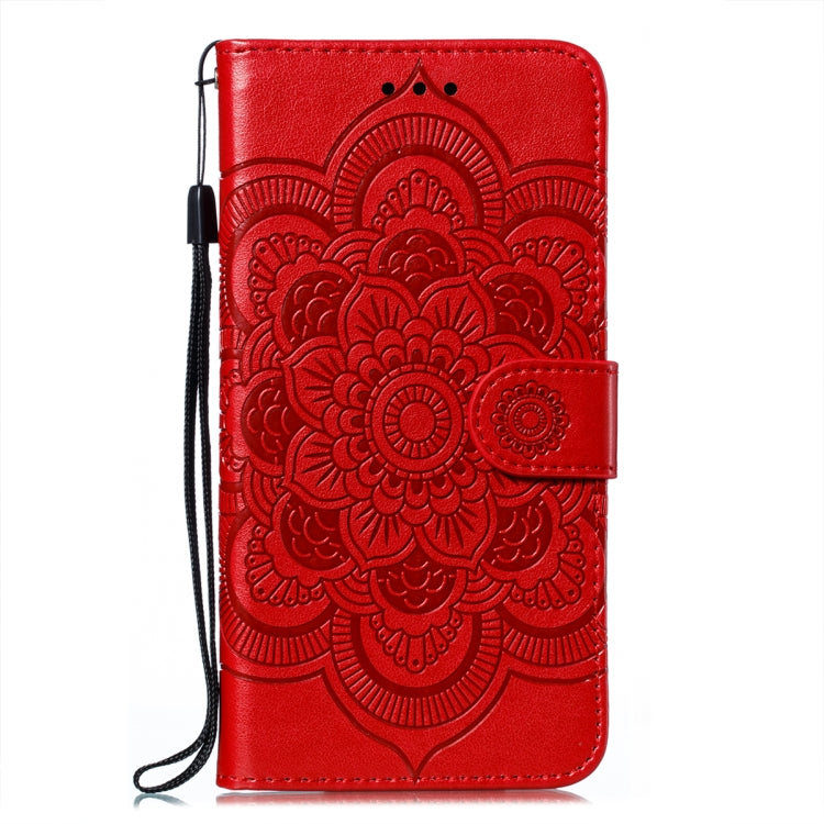 Red embossed mandala folio phone case with side lanyard strap and card slots.