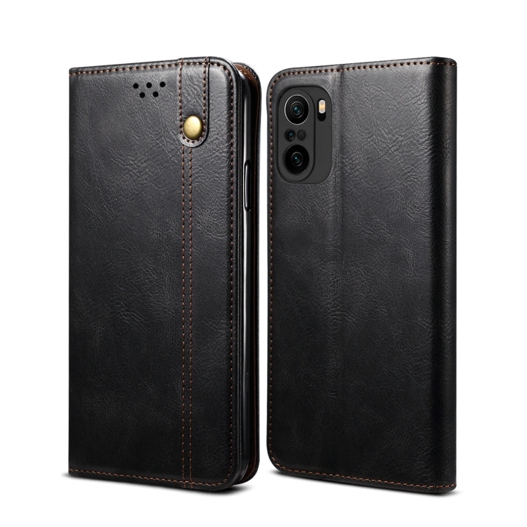 Black leather flip phone wallet case with card slots and camera cutout, visible side view.