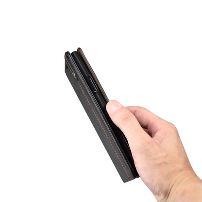 Black leather flip phone wallet case with thin side profile and stitched trim.