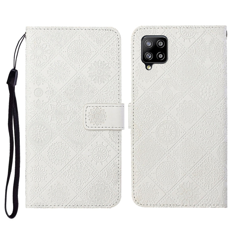 Embossed leather flip phone case with card slots, lanyard strap; white textured pattern, phone cutout