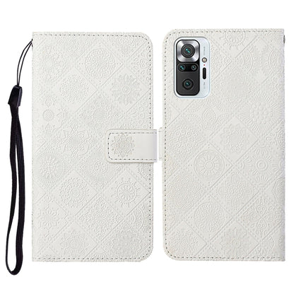 White embossed flip leather phone wallet case with card slots and wrist lanyard strap.