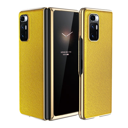 Yellow leather-texture protective phone case with gold-tone edges and dual rear cameras