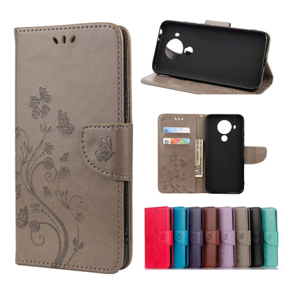 Taupe brown leather flip phone case with butterfly floral pattern, holder and card slots