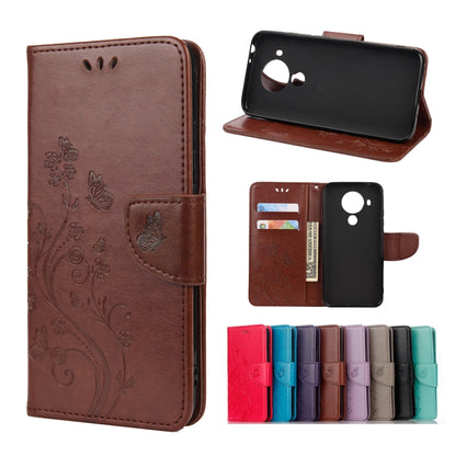 Brown leather flip phone case with butterfly floral pattern, holder and card slots