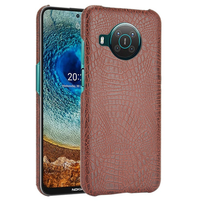 Brown crocodile-texture phone case with camera cutout and raised edges