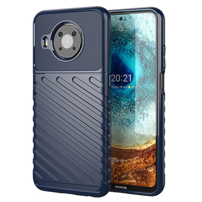 Blue phone case with textured ridges and circular camera area