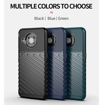 Phone cases in multiple colors: black, blue, and green with textured ridges