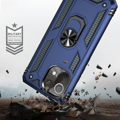Blue rugged phone case with rotating metal ring holder and textured grip panels.