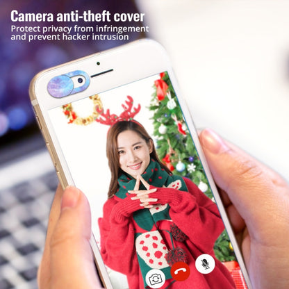 Oval webcam cover on a phone camera lens opening with space-themed design