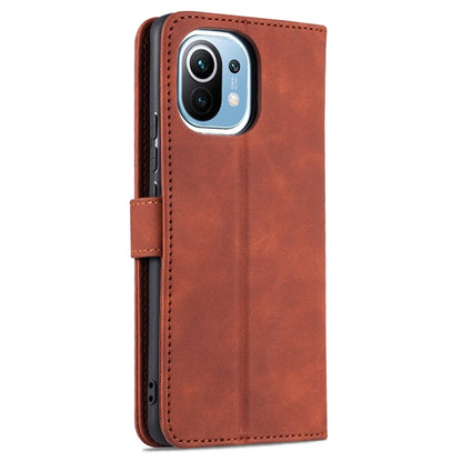 Brown flip leather phone case with camera cutout and side card holder tab.