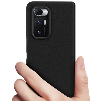 Black frosted IMAK hard case held in hand; camera module opening visible