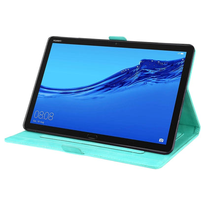 Teal leather flip tablet case with butterfly-heart pattern, folded as a landscape stand