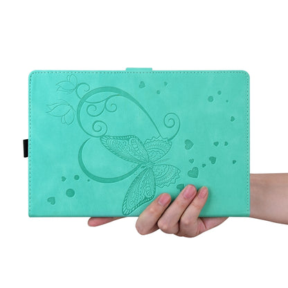 Teal leather wallet-style tablet case with butterfly-heart pattern, held in hand