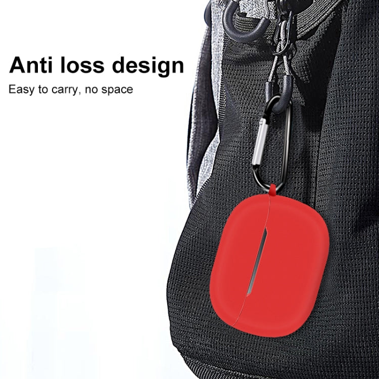Red silicone earbud case with carabiner clip, attached to a bag zipper