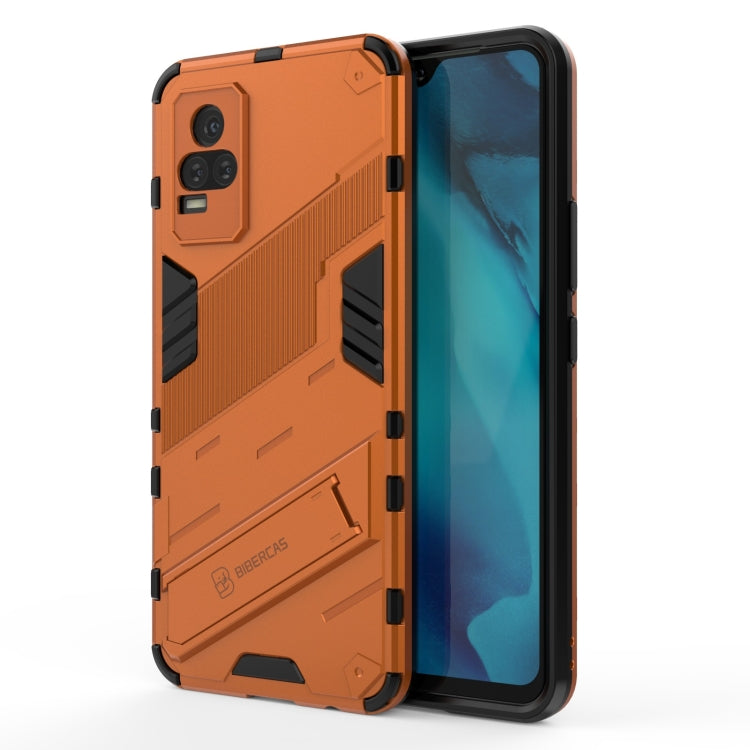 Orange shockproof phone case with rugged armor design, raised edges, built-in holder