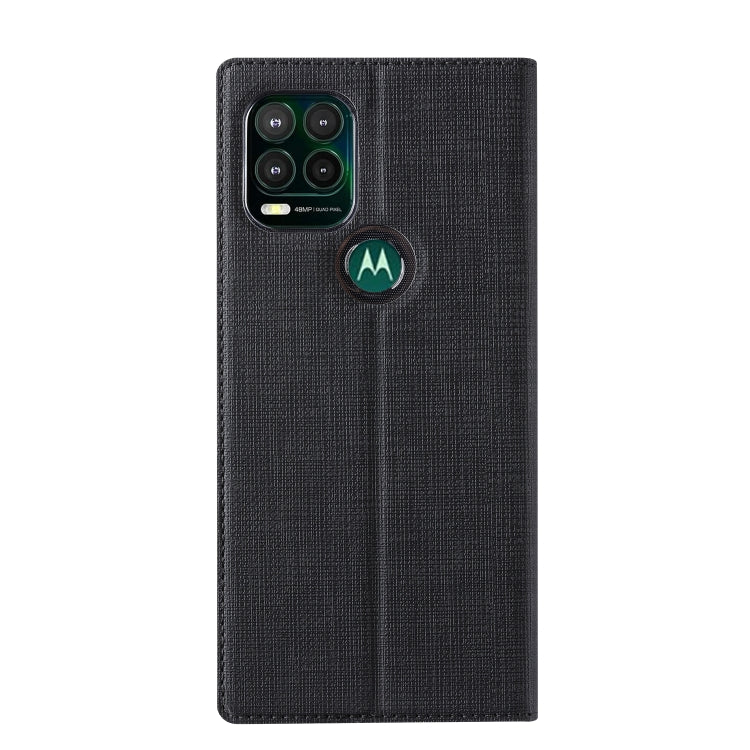 Magnetic flip phone case in dark fabric with camera cutout and round holder