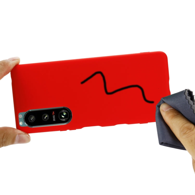 Red liquid silicone phone case with camera cutouts and side openings