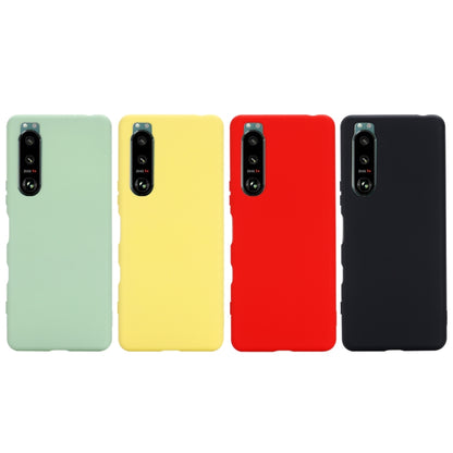 Set of solid liquid silicone phone cases in mint, yellow, red, and black