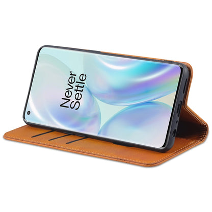 Orange leather flip phone case with magnetic closure and propped viewing stand