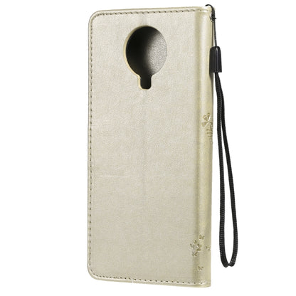 Gold flip PU leather phone case with keyhole cutout and side wrist strap
