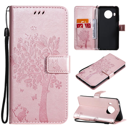Light pink PU leather phone case with embossed tree, cat, butterfly pattern; card slots, stand; lanyard.
