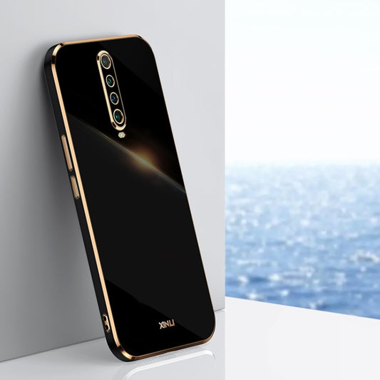 Black TPU phone case with gold-tone frame and vertical quad-camera cutout