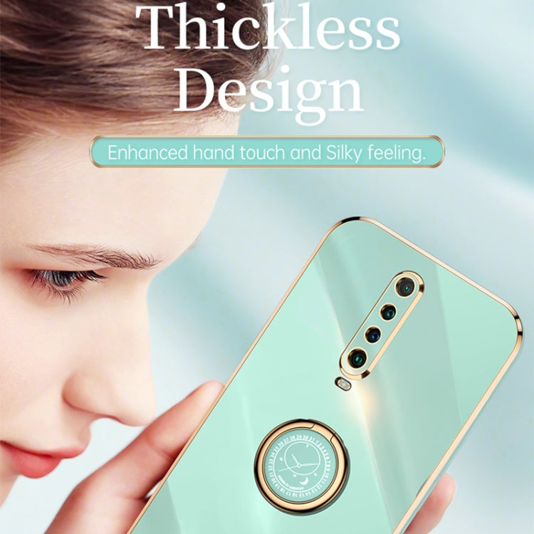 Mint green TPU phone case with gold ring holder and dual-lens camera cutout