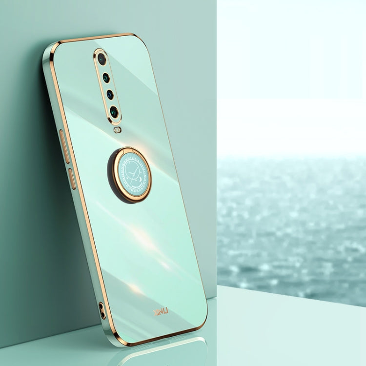 Mint blue TPU phone case with ring holder and gold-toned trim; visible camera cutouts