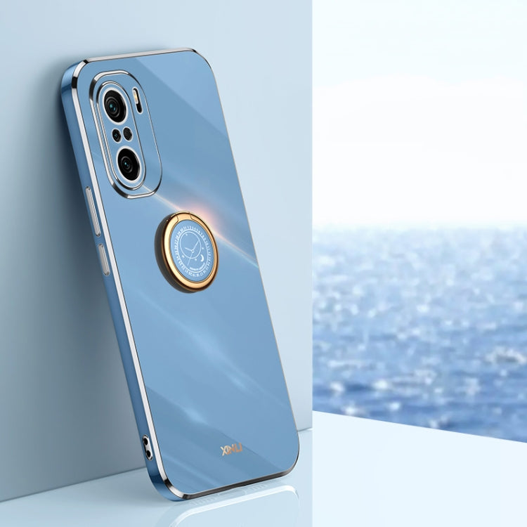 Light blue TPU phone case with ring holder and gold-toned trim; visible camera cutouts