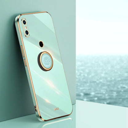 Glossy mint blue phone case with gold-tone ring holder and camera cutout