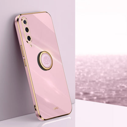 Glossy pink phone case with gold-tone ring holder and camera cutouts