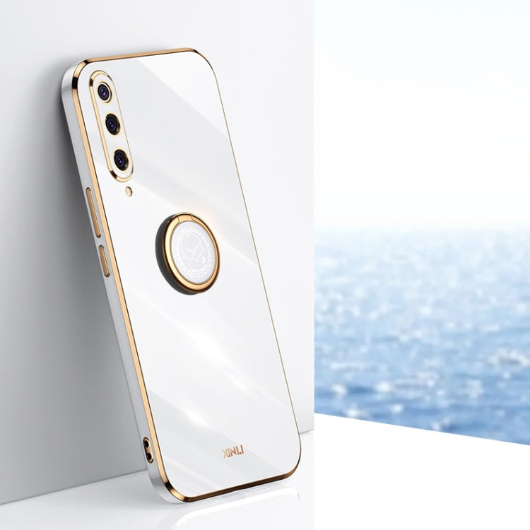 Glossy white phone case with gold-tone ring holder and dual camera cutouts